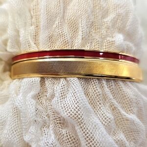 Monet goldtone bangles, one w/textured lines 1 w/ red enamel excellent condition
